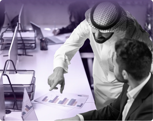Colleagues reviewing charts together at a desk