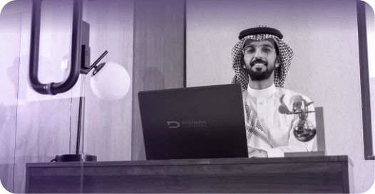 Professional in traditional attire working on a laptop